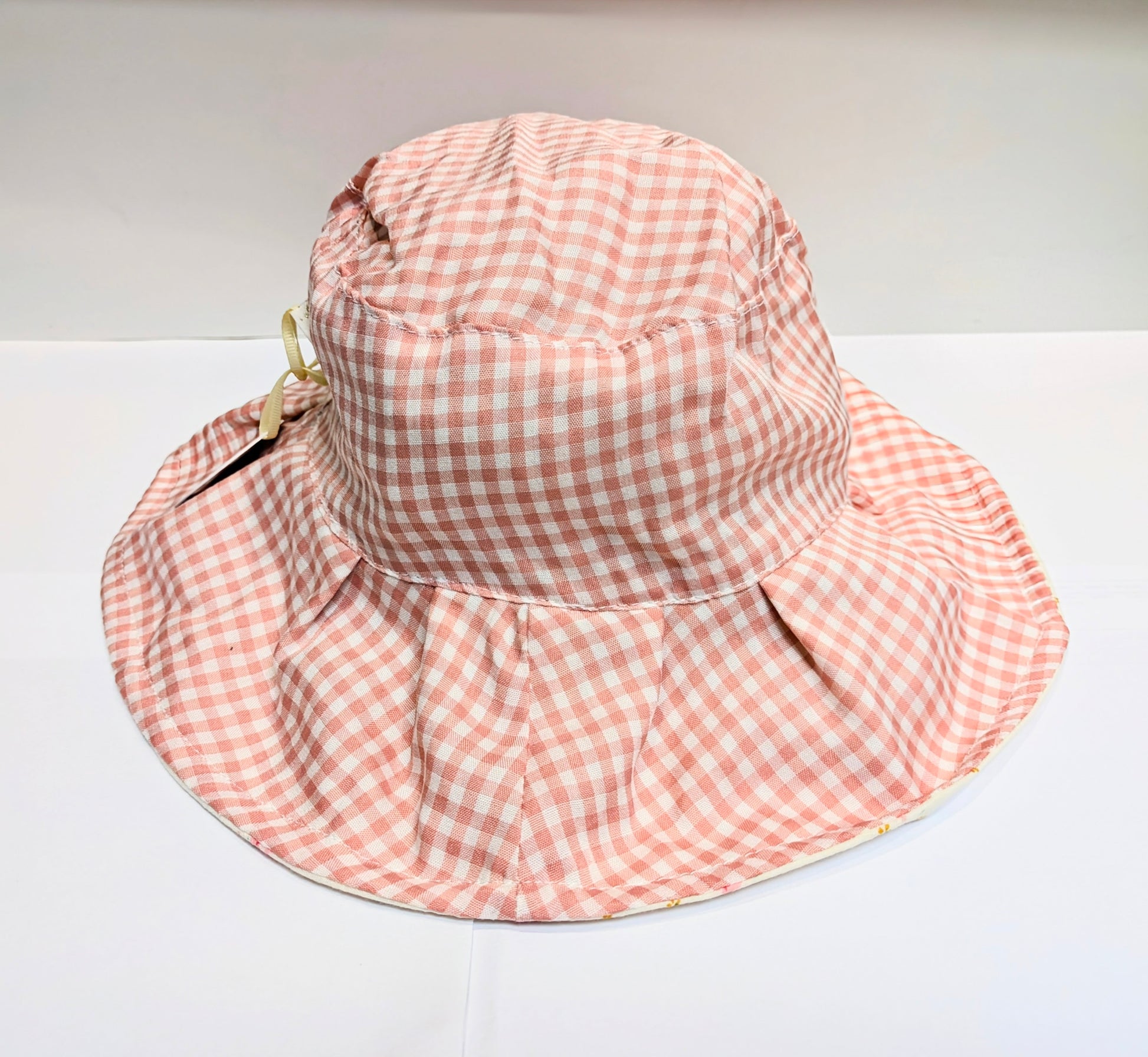 A pink and white gingham sun hat by Rockahula on a white background