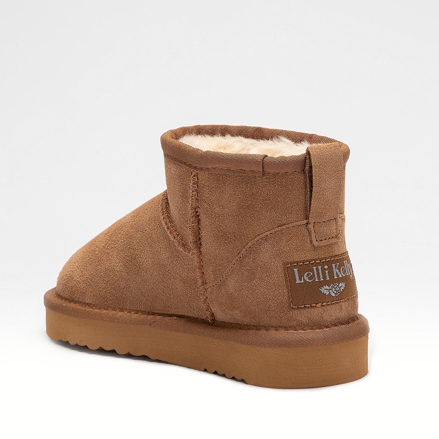 A girls warm lined pull on ankle boot by Lelli Kelly, style LKHK2262 Giulia, in brown suede with cream fur lining. Angled view back.