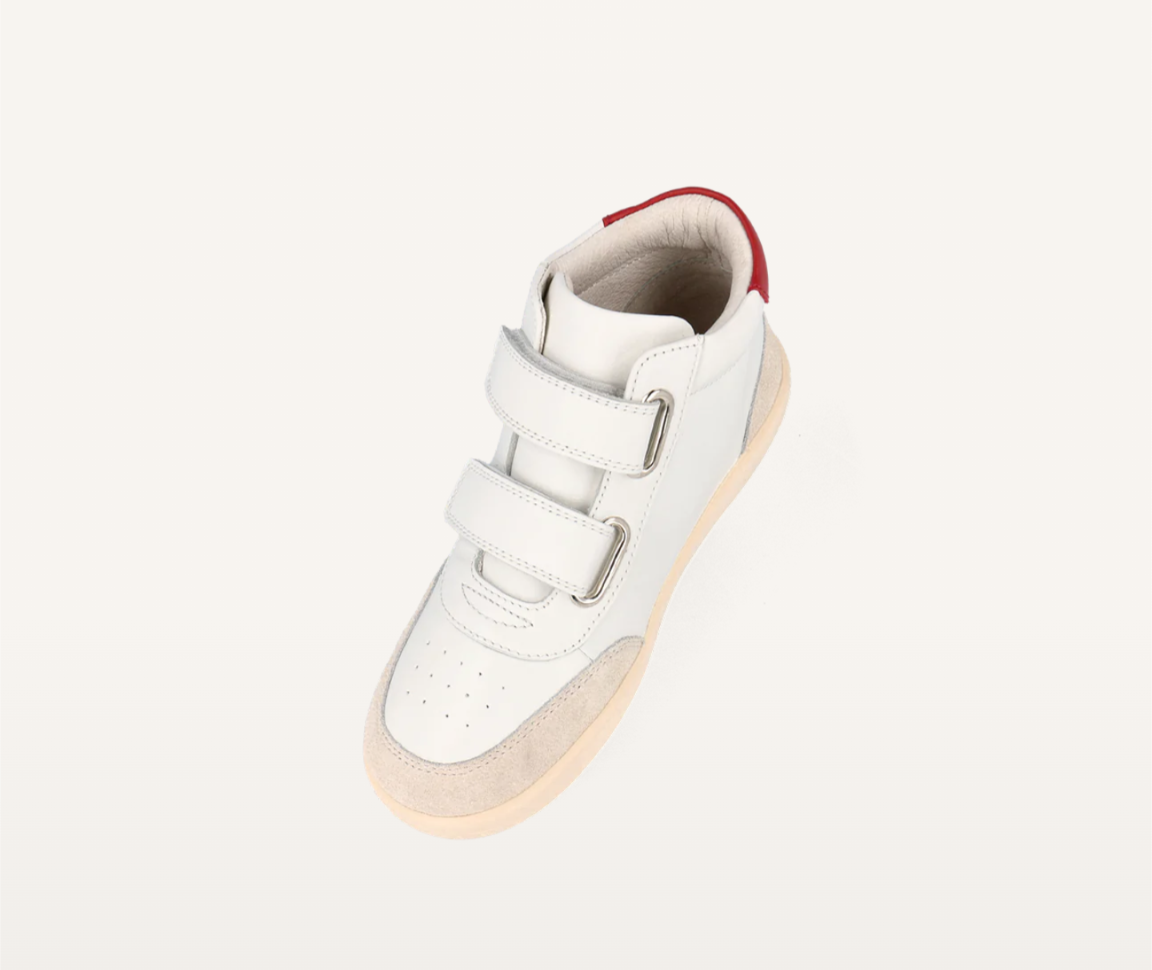 A unisex high top casual boot by Bobux, style Champ, in white with pink and red trim and double velcro fastening. Angled view.