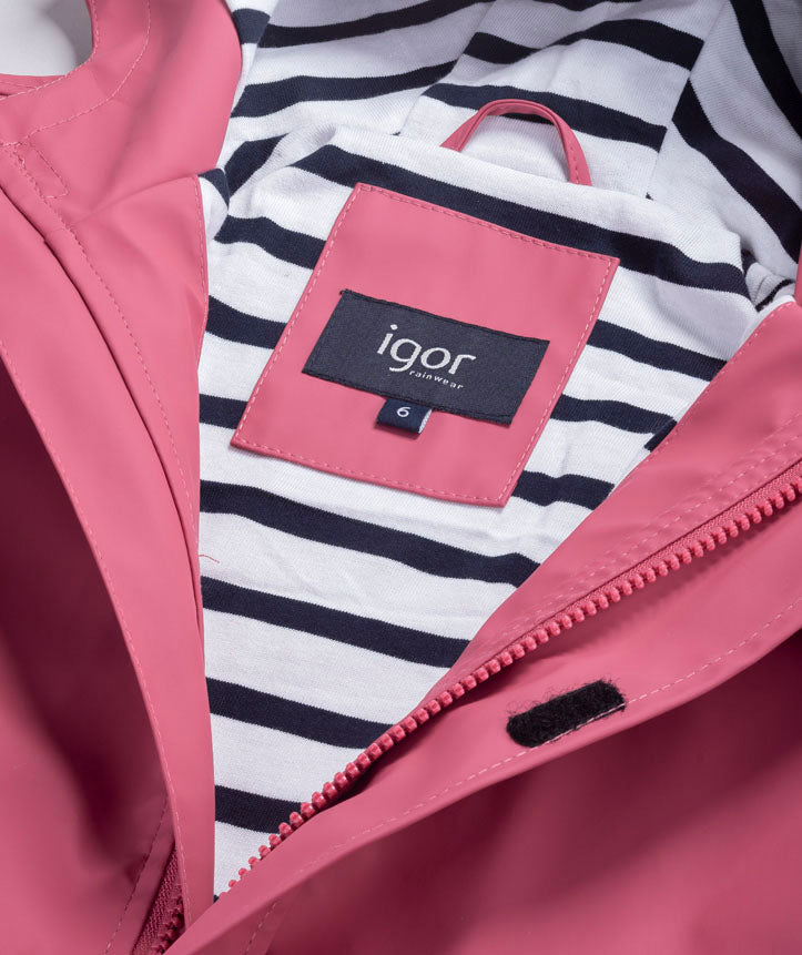 A girls hooded rain coat by Igor, style Euri, in pink with pockets and navy and white stripe lining. Close up of label and lining of coat.