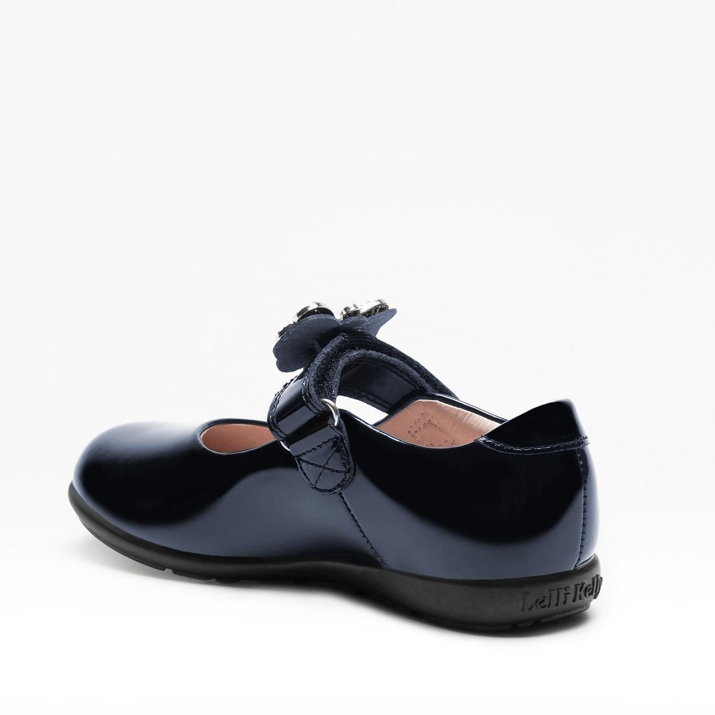A girls Mary-Jane school shoe by Lelli Kelly, style LKSO8641 Luna 2 in Navy patent leather with velcro fastening and detachable multi coloured embellished butterfly. Angled view of left side..