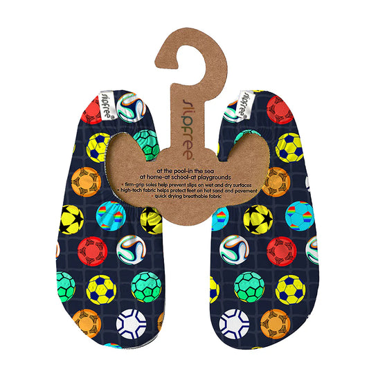 A pair of swim shoes by Slipfree, style Yamal in dark blue with multicoloured football pattern, hanging on cardboard hanger