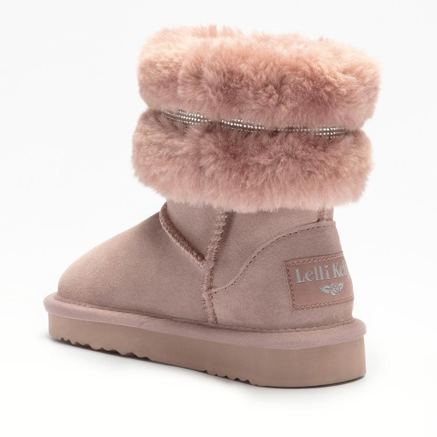 A girls pull on calf length boot by Lelli Kelly, style LKHA3766, in blush pink suede with fur cuff and diamante trim.  Angled view of back.
