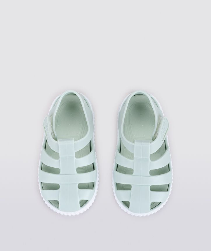 A unisex Jelly shoe by Igor, style Nico in mint green with a white sole, velcro fastening. Above view of a pair.