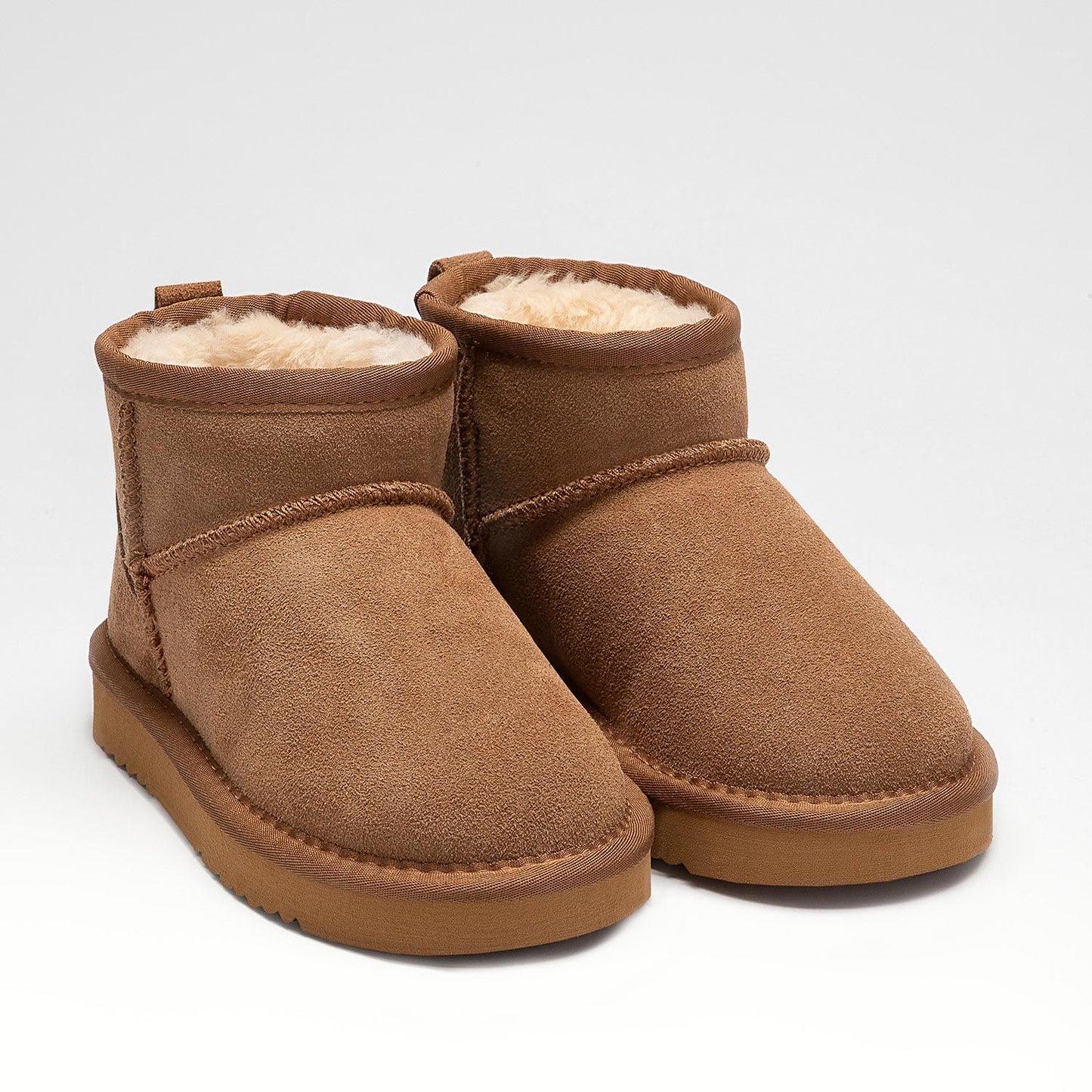 A girls warm lined pull on ankle boot by Lelli Kelly, style LKHK2262 Giulia, in brown suede with cream fur lining.  Angled view.