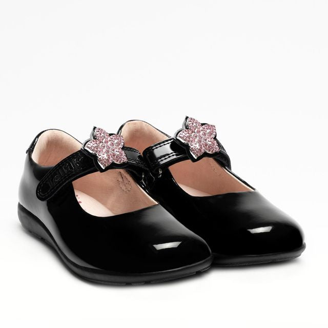 A girls Mary Jane school shoe by Lelli Kelly, style LKSO8481CVR Daisy, in black patent with detachable daisy embellished attachment. Velcro fastening. Angled view of a pair.