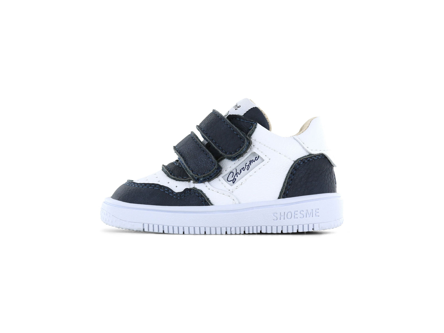 A boys mid top trainer by Shoesme, style BN25S006-B in white and navy, double velcro straps. Left side view.