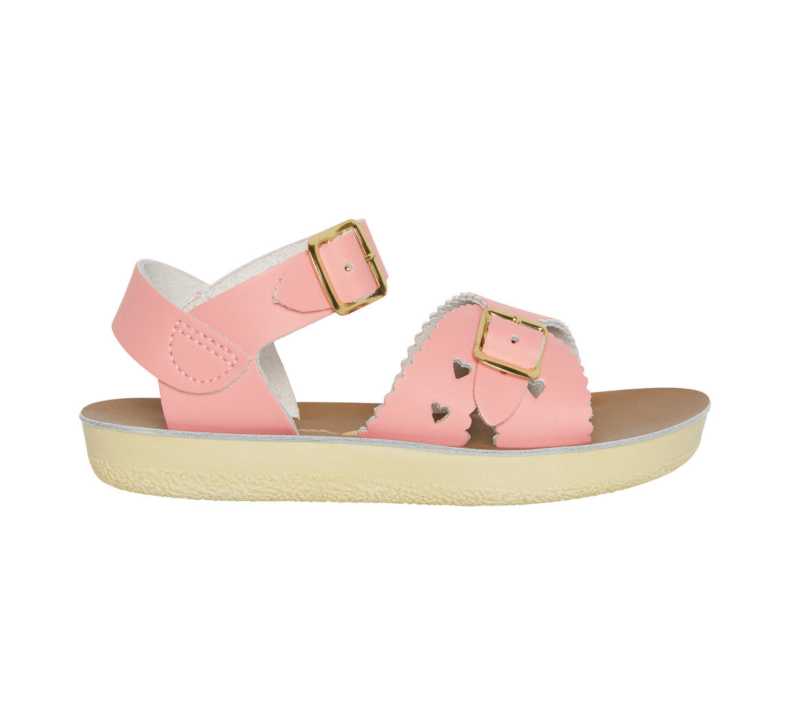 A girls sandal by Salt Water, style Sweetheart in pink, buckle fastening. Left side view.