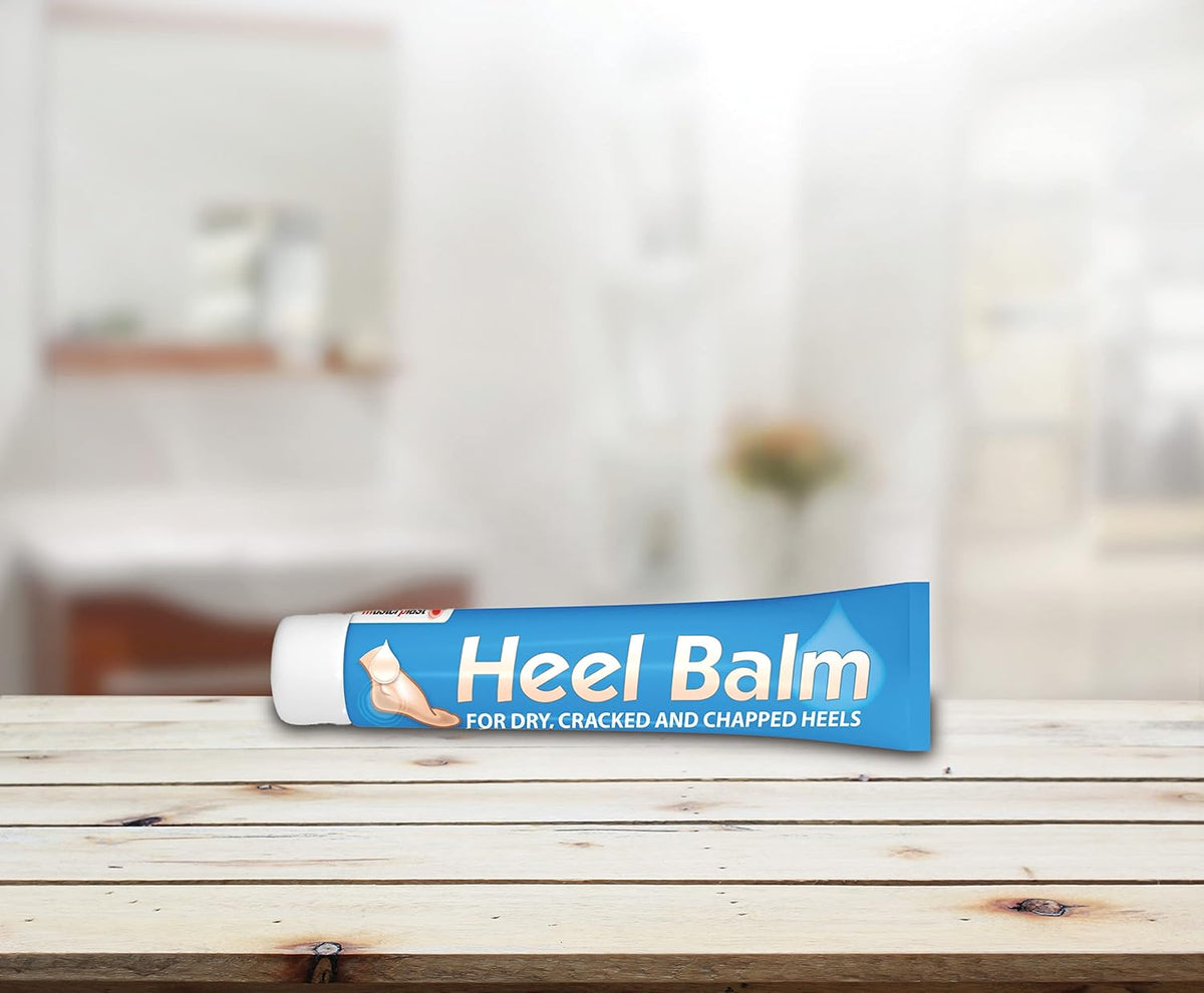 masterplast Heel Balm blue tube on wooden bench with blurred background