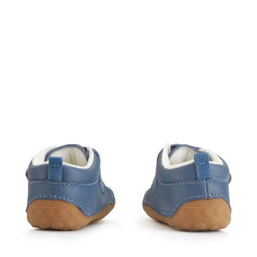 A boys pre-walker by Start-Rite, style Dinky, in blue with dinosaur motif on the velcro strap. Back view of a pair.