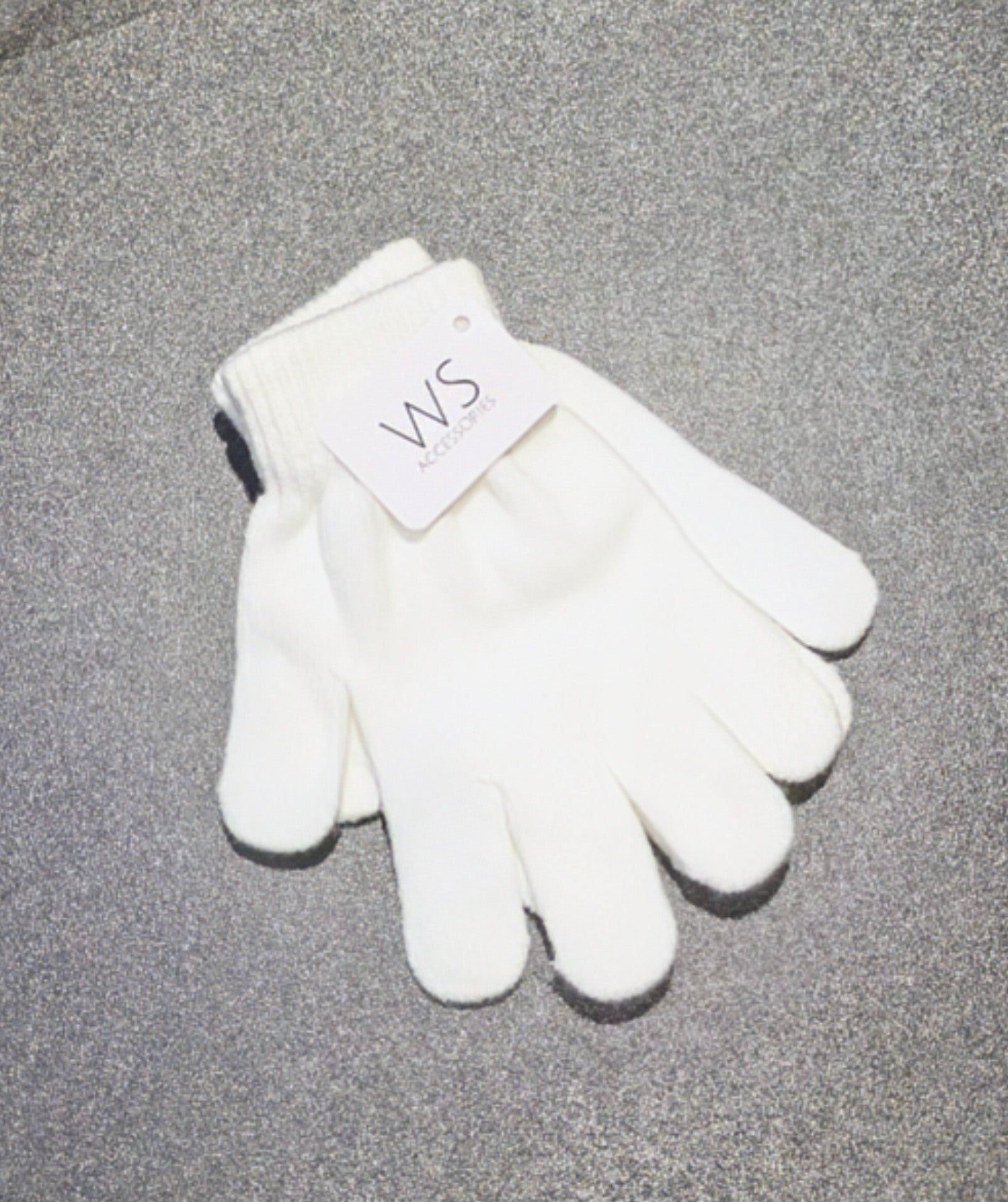 White WS Accessories glove with a brand tag on a grey background. Above angled view.