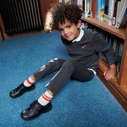 A boys school shoe by Start-Rite, style Engineer, in black leather with double velcro fastening. Lifestyle image.