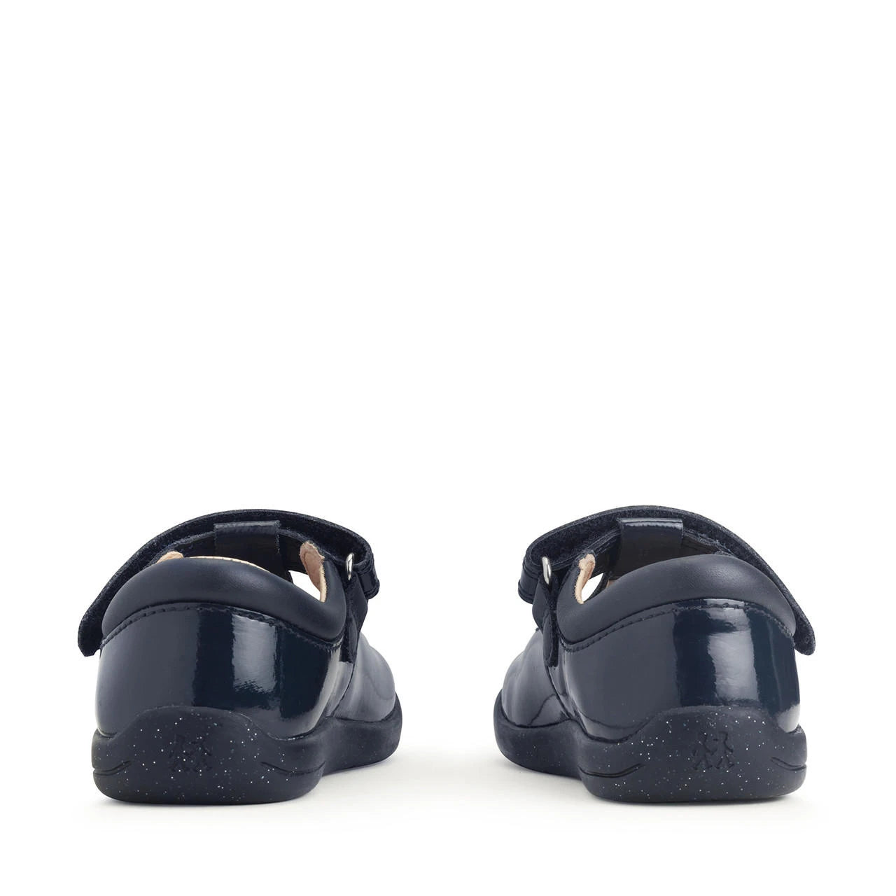 A girls t-bar shoe by StartRite, style Puzzle in patent navy, with flower design on the front and glitter in a black sole. Back view of pair