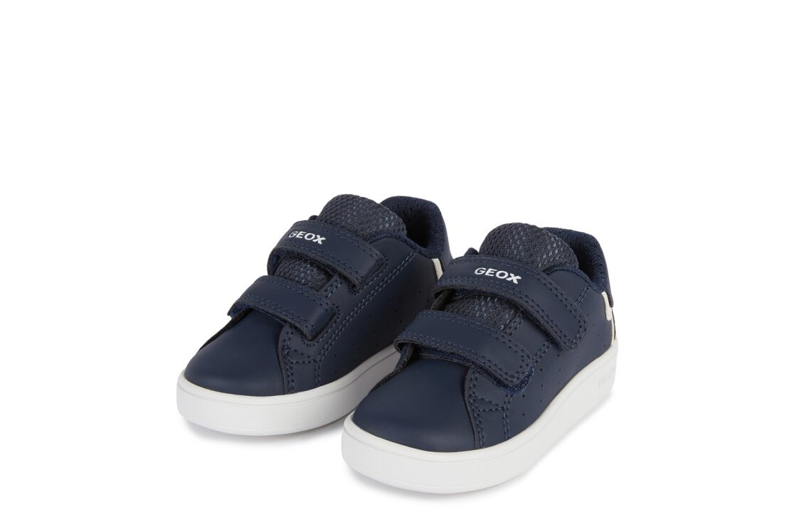 A boys casual shoe by Geox, style B Eclyper in navy with white trim, double velcro fastening. Angled left side view.