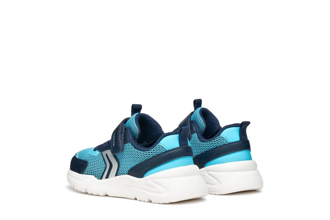 A boys trainer by Geox, stye J Loftus in sky / nay, velcro fastening with elastic laces. Rear angled view of pair.