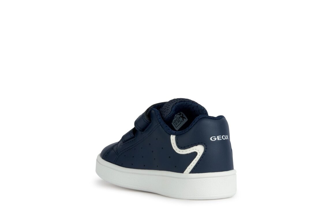 A boys casual shoe by Geox, style B Eclyper in navy with white trim, double velcro fastening. Angled left side view.