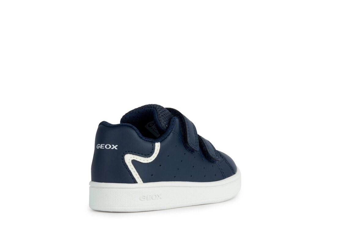 A boys casual shoe by Geox, style B Eclyper in navy with white trim, double velcro fastening. Angled right sided view.