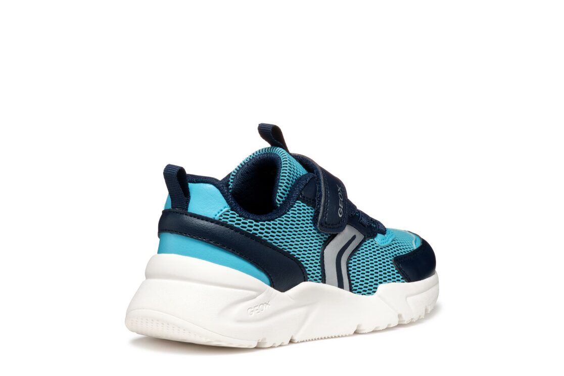A boys trainer by Geox, style J Loftus in sky / Navy. Velcro fastening with elastic laces. Outer right side rear angled view.
