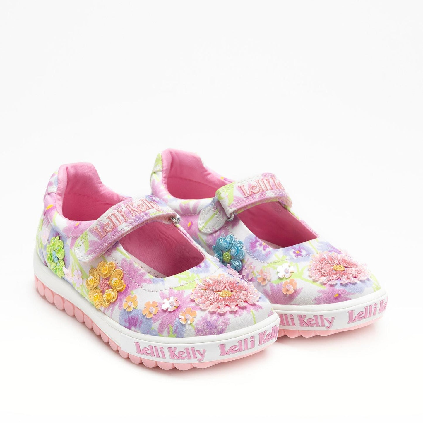 A girls embellished canvas Mary Jane by Lelli Kelly, style LKED4911 Eloise Dolly, in white multi with velcro fastening. Angled view of pair.