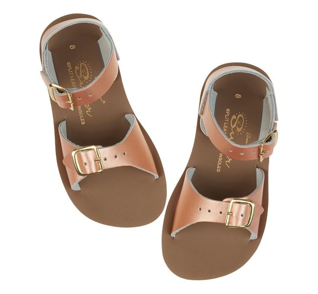 A girls sandal by Salt Water, style Surfer in rose gold, buckle fastening. Above view of a pair.