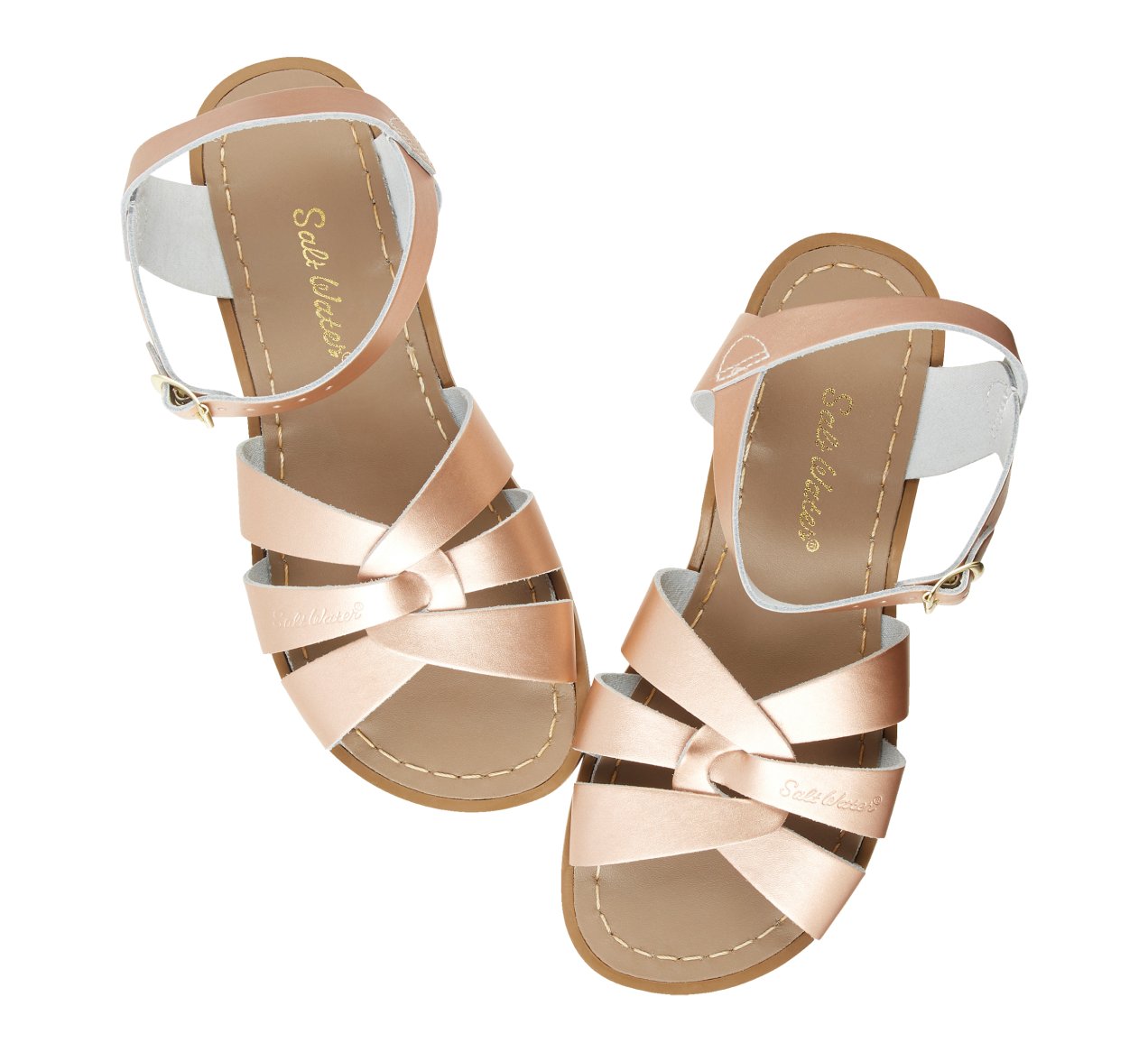 An original girls sandal by Salt Water Sandals in rose gold with single buckle fastening around the ankle. Open Toe and Sling-back with woven detail on the front. Top view.