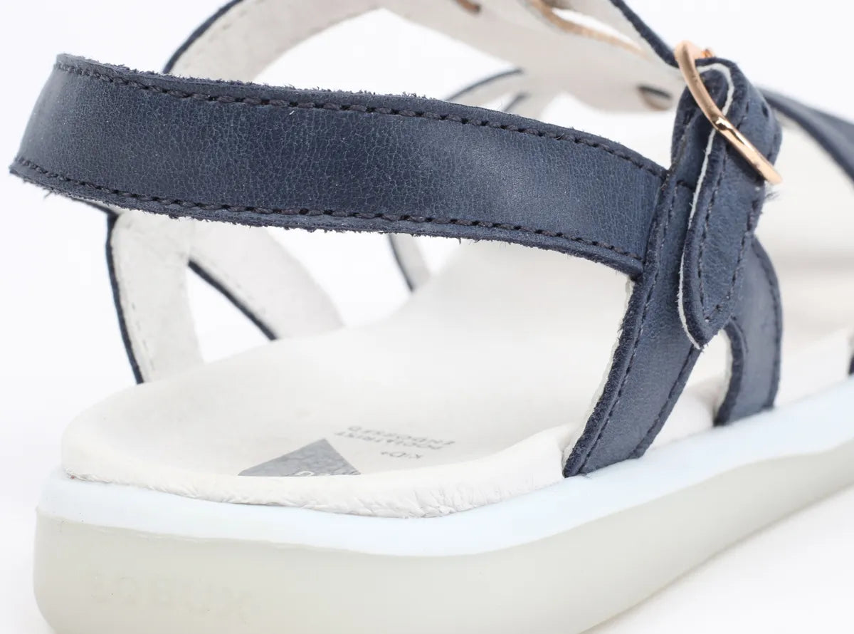 A girls open toe sandal by Bobux, style Pixie, in navy and gold with buckle fastening. Back view.