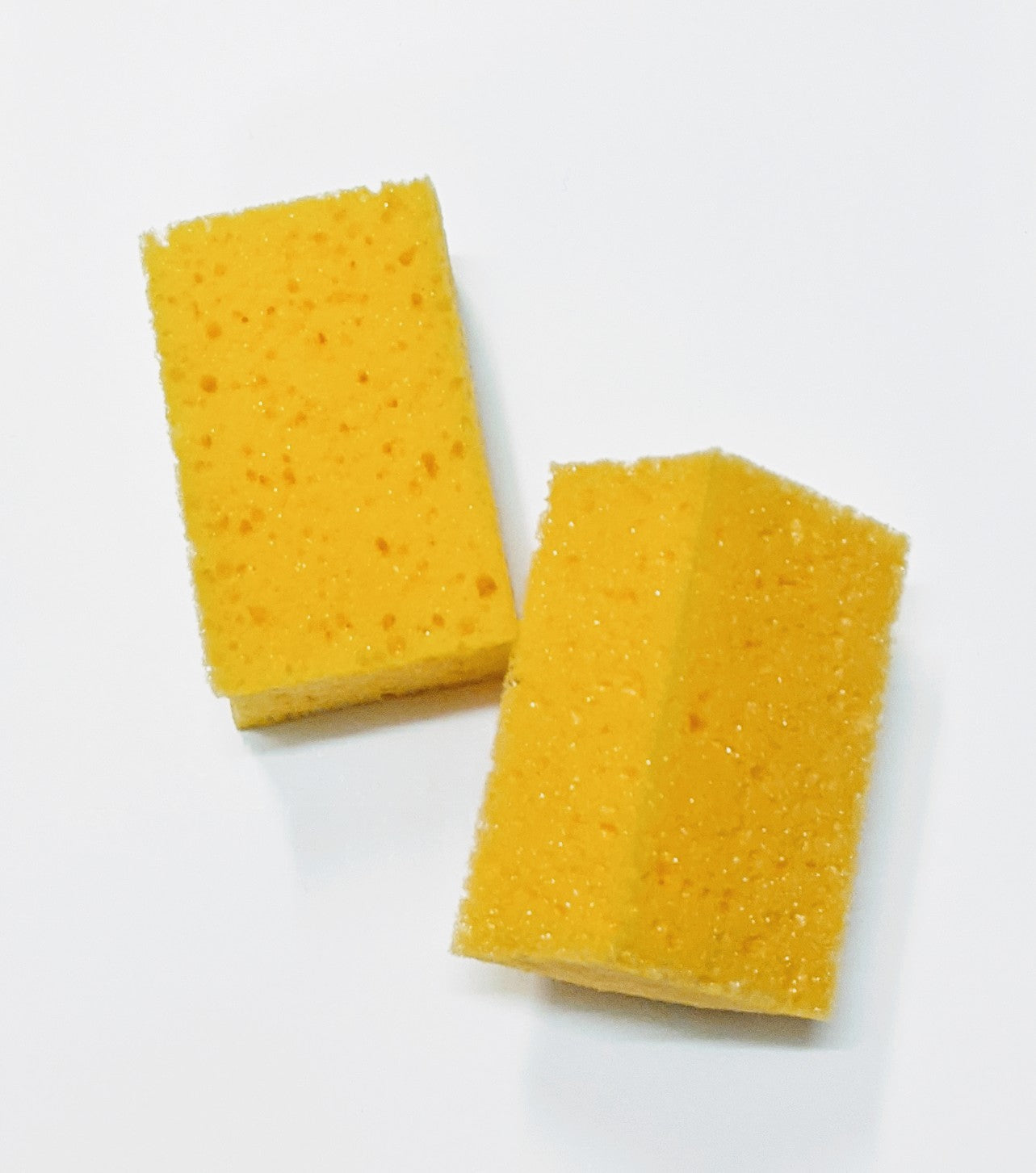 A small shoe cleaning sponge by Shoe String. Above view.